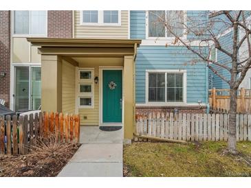 Charming two-story home with a welcoming teal-colored front door and cozy porch at 2212 Tamarac St, Denver, CO 80238