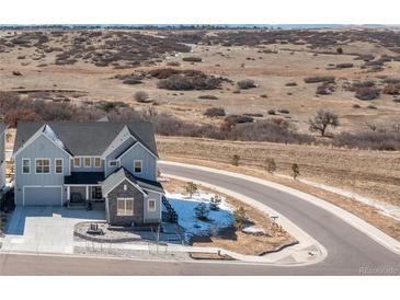 Charming two-story home with stone accents and attached garage located on a cul-de-sac at 7517 Copper Sky Ct, Castle Pines, CO 80108