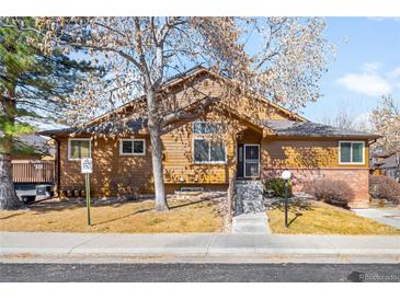 Charming single-Gathering home featuring mature trees, a well-maintained lawn, and a cozy, inviting facade at 11945 W 66Th Pl # A, Arvada, CO 80004