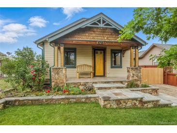 Charming home showcasing a welcoming front porch, stone accents, and a beautifully landscaped front yard at 4716 Broadway, Denver, CO 80216