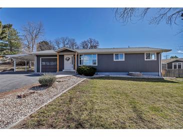 Charming single-story home with gray siding, a carport, and a well-maintained lawn at 3604 Collins St, Castle Rock, CO 80108