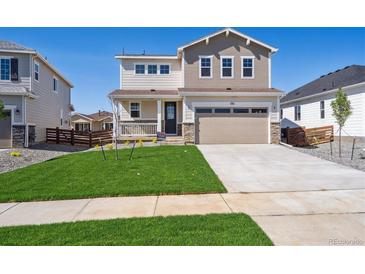 Charming two-story home featuring a well-manicured lawn and an attached two-car garage at 1311 Rock Cliff Ave, Erie, CO 80516