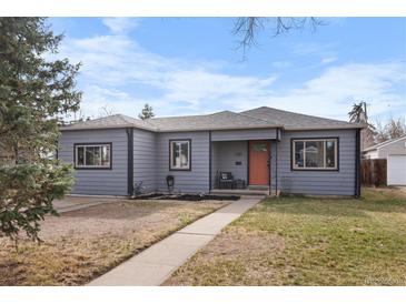 Charming gray single-story home featuring a well-maintained lawn and inviting orange front door at 2381 Newark St, Aurora, CO 80010
