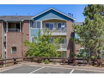 Attractive two-story building featuring brick and blue siding and lovely balconies at 2672 S Cathay Way # 304, Aurora, CO 80013