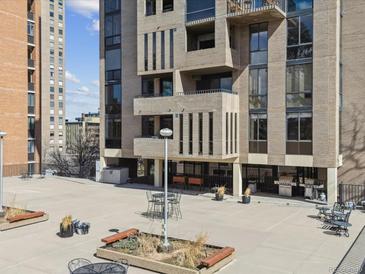 Outdoor patio with barbecue, seating area, and views of the building's architectural design at 1111 Race St # 3A, Denver, CO 80206