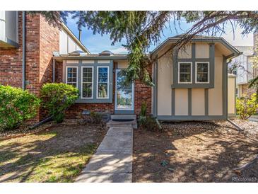 Charming home featuring a brick facade, large windows, and well-maintained landscaping at 3082 W 107Th Pl # H, Westminster, CO 80031