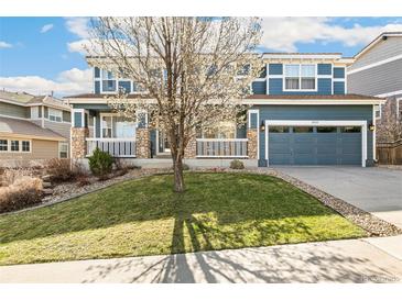 Charming blue two-story home with stone accents, landscaped front yard, and attached two-car garage at 3532 Springbriar Dr, Castle Rock, CO 80109