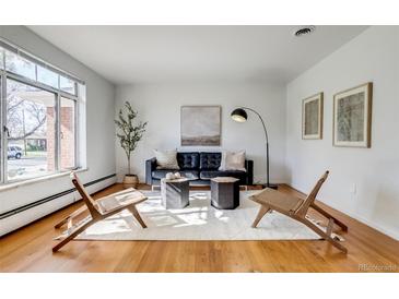 Bright living room with hardwood floors, modern furniture, and large windows for natural light at 500 Fulton St, Aurora, CO 80010