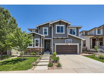 Charming two-story home with a well-manicured front yard and attached two-car garage at 10694 Cedarcrest Cir, Highlands Ranch, CO 80130