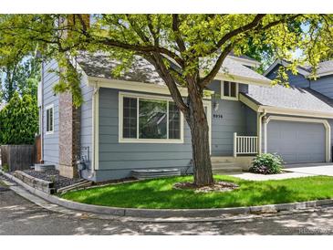 Charming home with a well-manicured lawn and mature trees shading the front at 8056 Meadowdale Sq, Niwot, CO 80503