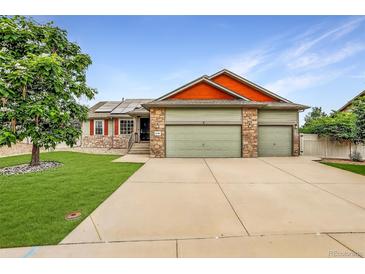 Charming two-story home featuring a three-car garage and a well-manicured lawn at 5193 Rustic Ave, Firestone, CO 80504