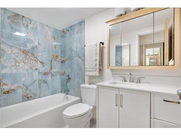 Updated bathroom with marble blue tile, modern vanity, mirror and shower-tub combination at 1021 Carr St # 37, Lakewood, CO 80214