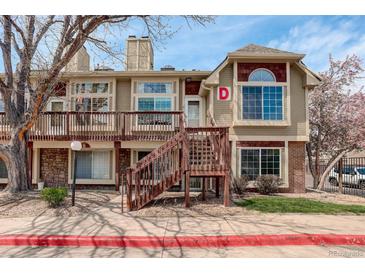Charming condo building with two stories, wood deck and siding, and well-maintained landscaping at 1885 S Quebec Way # D22, Denver, CO 80231