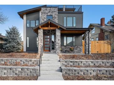 Contemporary two-story home featuring a stone facade, a front porch and a roof-top terrace at 5086 N Raleigh St, Denver, CO 80212