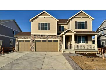 Two-story house with tan siding, three-car garage, and a small front yard at 25041 E 38Th Ave, Aurora, CO 80019