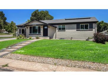 Charming single-story home with a well-manicured lawn and inviting entryway at 3999 W Chenango Ave, Littleton, CO 80123