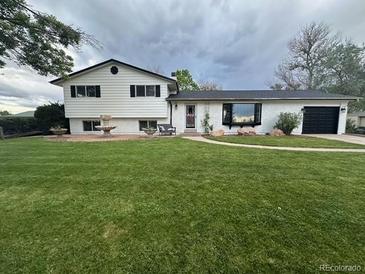 Charming home with a large, well-maintained front yard and decorative fountain at 12901 2Nd St, Parker, CO 80134