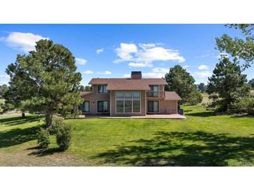 Two-story home with large windows and a spacious backyard at 9696 E Sand Lily Ln, Parker, CO 80134