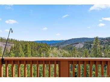 Capture the stunning view from the deck into the mountainous surrounding pine tree forest at 278 Snowshoe Cir, Breckenridge, CO 80424