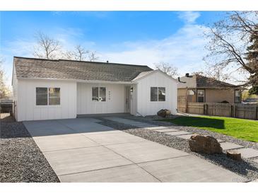 Charming single-story home with a freshly painted white exterior and well-maintained front yard at 4910 Alcott St, Denver, CO 80221