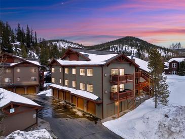 A charming mountain condo complex with covered parking and outdoor decks covered in snow at 303 Pelican Cir # 1901, Breckenridge, CO 80424