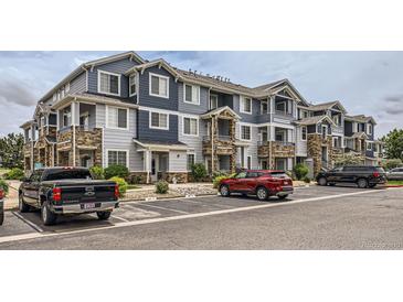 Attractive multi-Gathering condo complex showcasing stone accents, covered balconies, and convenient parking at 5255 Memphis St # 224, Denver, CO 80239