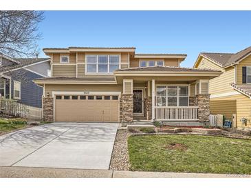 Charming home with a two-car garage, lovely porch, and manicured lawn at 3523 Brushwood Dr, Castle Rock, CO 80109