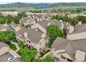 Scenic aerial view of townhomes in a well-maintained community with mountain backdrop at 9692 W Coco Cir # 304, Littleton, CO 80128