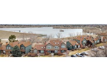 An aerial view of the townhome community near a large lake with walking trails, dam and open spaces at 17467 E Rice Cir # C, Aurora, CO 80015