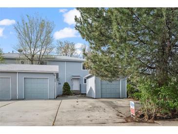 Charming exterior of a two-story home with a well-maintained lawn and attached garages at 2862 W Warren Ave, Denver, CO 80219