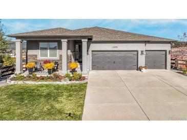 Charming single-Gathering home boasts a well-manicured lawn and a welcoming front porch with stylish decor at 16088 Denver Pacific Dr, Monument, CO 80132