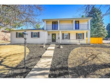 Charming two-story home features a welcoming front porch, manicured landscaping and a beautiful entry way at 3798 S Wabash St, Denver, CO 80237