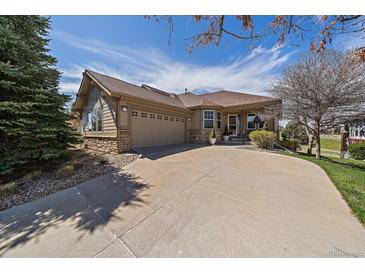 Charming ranch-style home with a well-maintained front yard and a two-car garage on a sunny day at 7895 S Zante Ct, Aurora, CO 80016