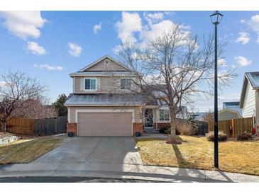 Two-story house with attached garage and landscaped yard at 22382 E Mercer Pl, Aurora, CO 80018