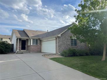 Charming one-story brick home featuring an attached two-car garage and a well-manicured front lawn at 18784 E Linvale Pl, Aurora, CO 80013