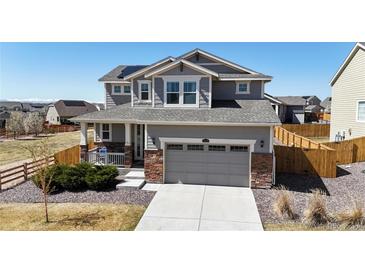 Charming two-story home features a well-manicured lawn, concrete driveway and two-car garage at 13485 Niagara St, Thornton, CO 80602