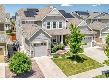 Charming home featuring solar panels, manicured lawn, and welcoming curb appeal at 14565 Vancouver Pl, Parker, CO 80134