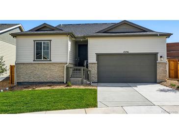 Charming single-Gathering home featuring a two-car garage and manicured lawn at 17156 W 92Nd Loop, Arvada, CO 80007