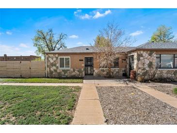 Charming stone-accented home with a well-maintained lawn and inviting curb appeal at 3251 N Adams St, Denver, CO 80205