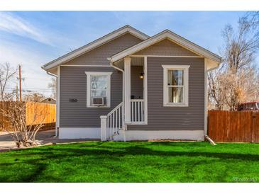 Charming single-story home with gray siding, front porch, and lush green lawn at 1350 Valentia St, Denver, CO 80220