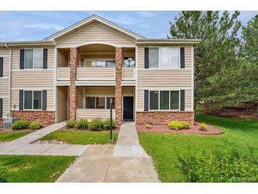 Charming two-story townhome with well-maintained landscaping, stone accents, and inviting front entry at 16848 E Gunnison Dr # 9E, Aurora, CO 80017
