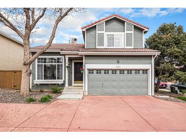 Charming two-story home with a red driveway, inviting curb appeal, and a well-manicured lawn at 1271 Braewood Ave, Highlands Ranch, CO 80129
