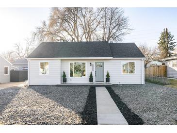 Charming craftsman style home with gray exterior, walkway, and landscaping at 5095 Umatilla St, Denver, CO 80221