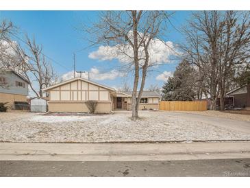 Ranch-style home with front yard, mature tree, and partial snow cover on a sunny day at 3596 E Fair Pl, Centennial, CO 80121