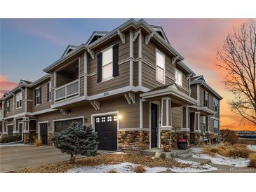 Charming townhome boasts a two-car garage and stylish stone accents, enhancing its curb appeal at 9031 Apache Plume Dr # E, Parker, CO 80134