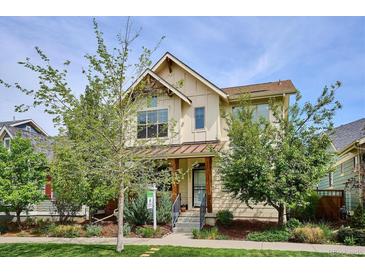 Charming two-story home featuring a welcoming front porch and well-maintained landscaping at 10671 E 28Th Ave, Denver, CO 80238
