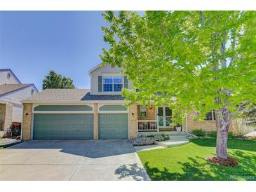 Charming two-story home with a three-car garage and beautiful landscaping in a suburban neighborhood at 15432 Greenstone Cir, Parker, CO 80134