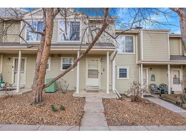 Tan colored townhome exterior with small front yard and walkway at 1818 S Quebec Way # 11-8, Denver, CO 80231