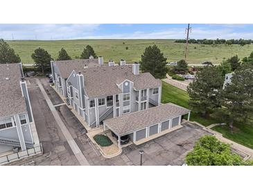 Inviting townhome complex boasts well-maintained landscaping and convenient covered parking at 7453 Singing Hills Dr, Boulder, CO 80301