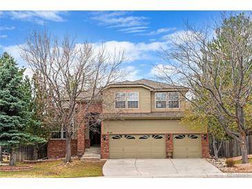 Charming two-story home with a well-manicured lawn and a three-car garage at 9743 Las Colinas Dr, Lone Tree, CO 80124